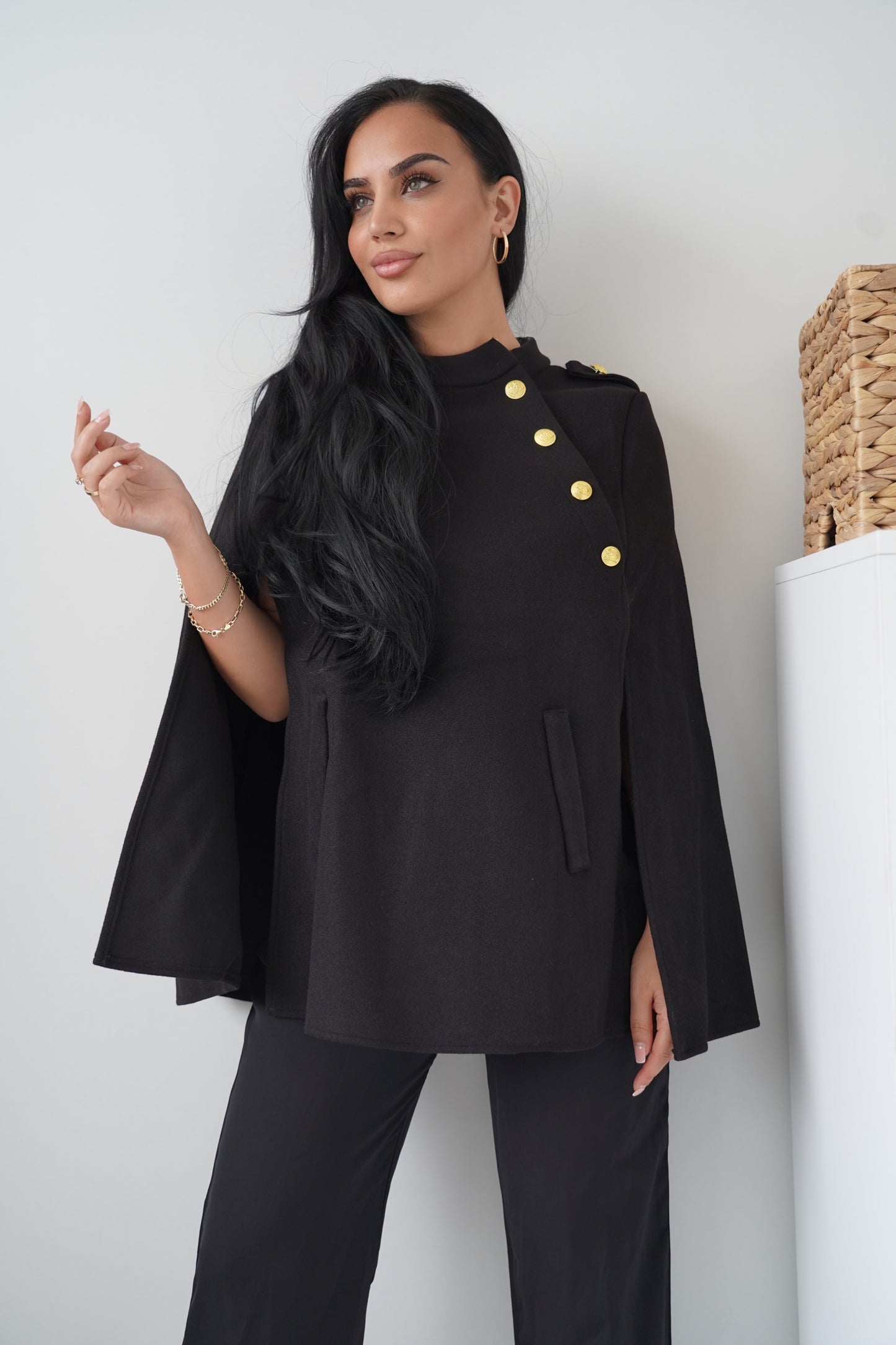 Elegant black cape with gold button