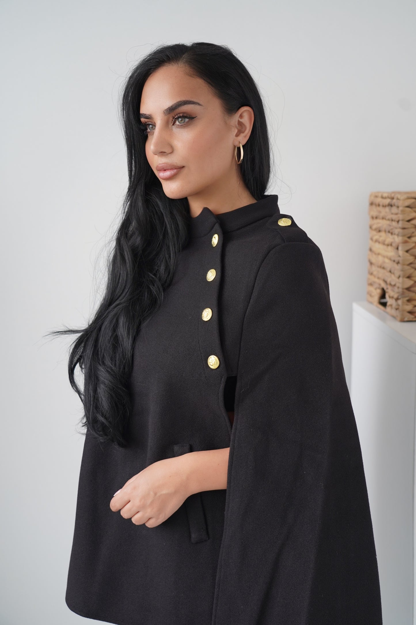 Elegant black cape with gold button