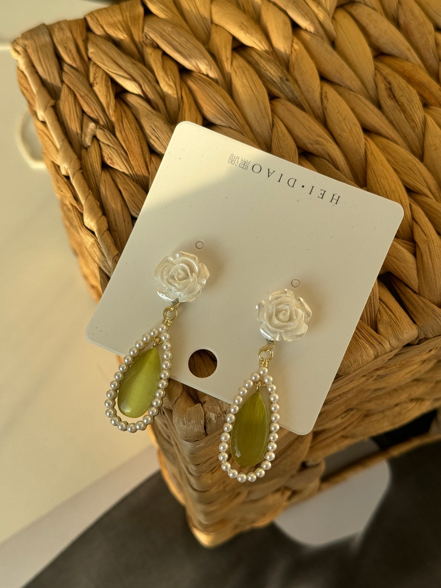 Soft rose, glowing green, and pearls that whisper elegance.