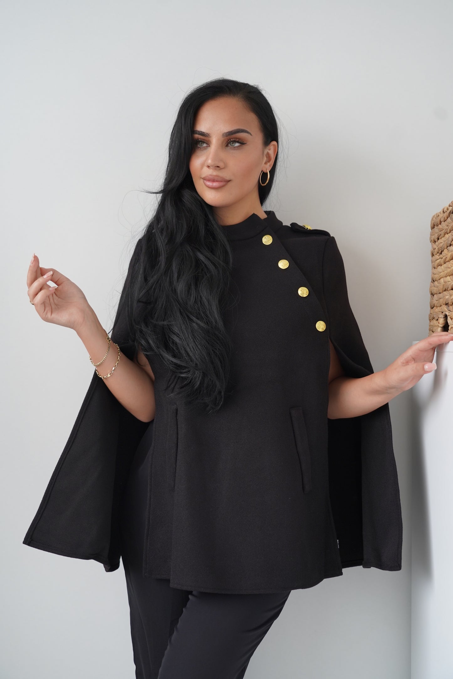Elegant black cape with gold button
