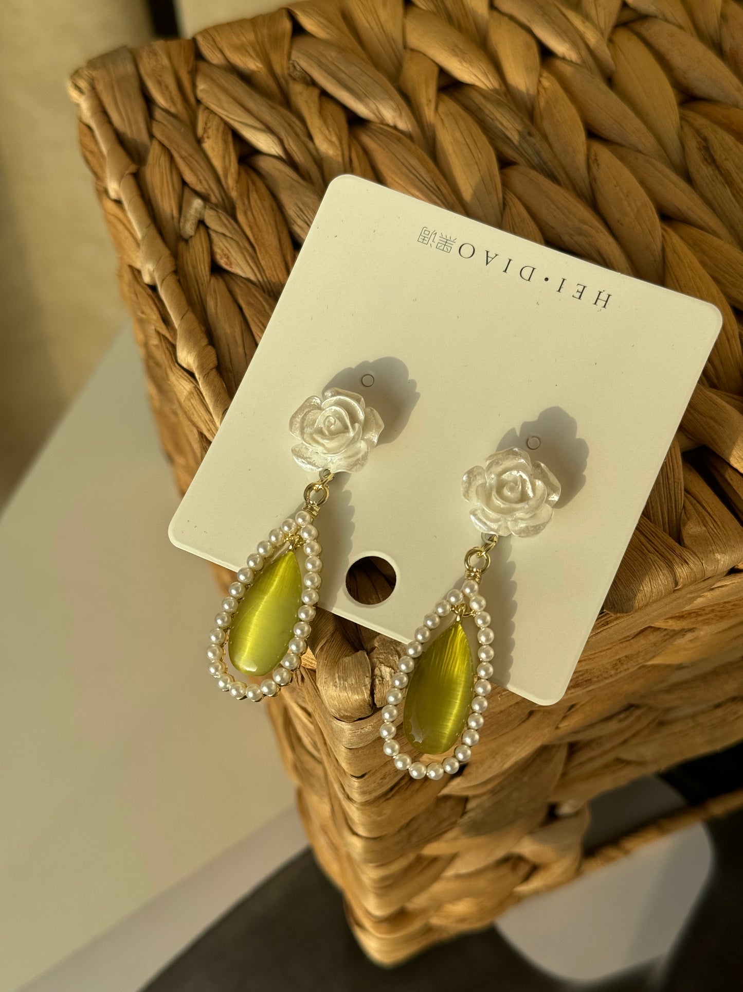 Soft rose, glowing green, and pearls that whisper elegance.