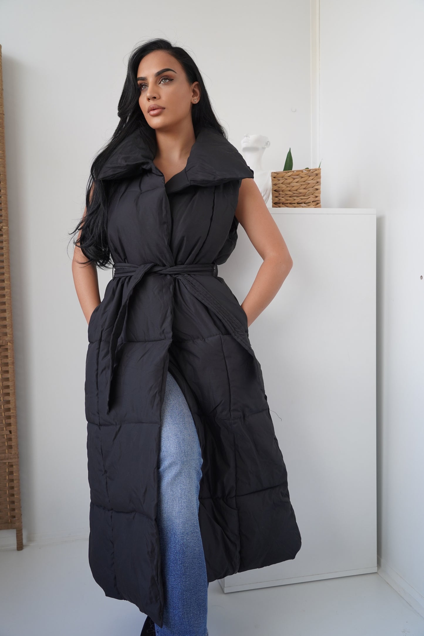 Long sleeveless padded vest designed for comfort and warmth.