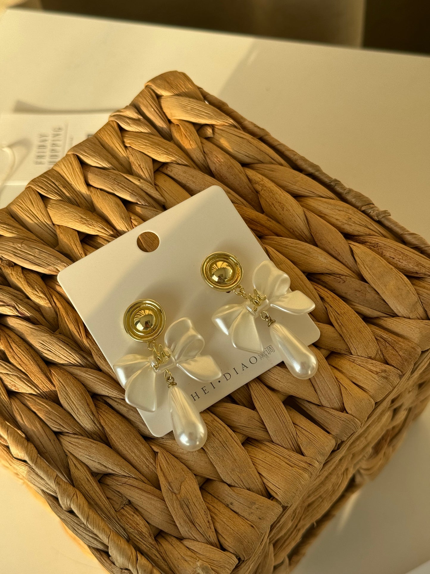 Grace in a bow, glow in a pearl