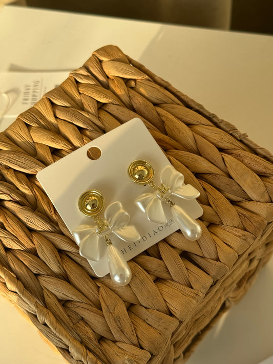 Grace in a bow, glow in a pearl