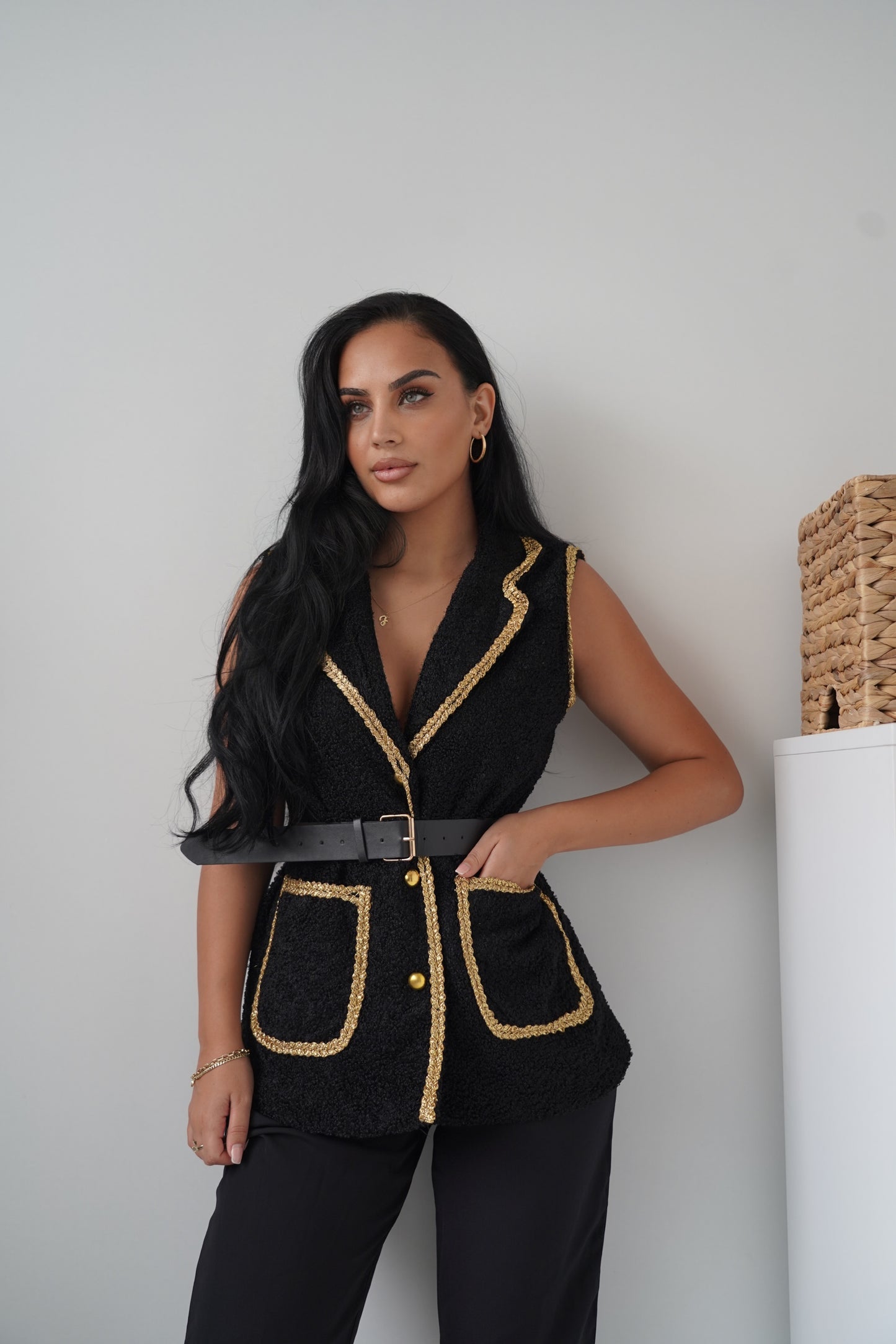 Elegant sleeveless black vest with golden braided trim