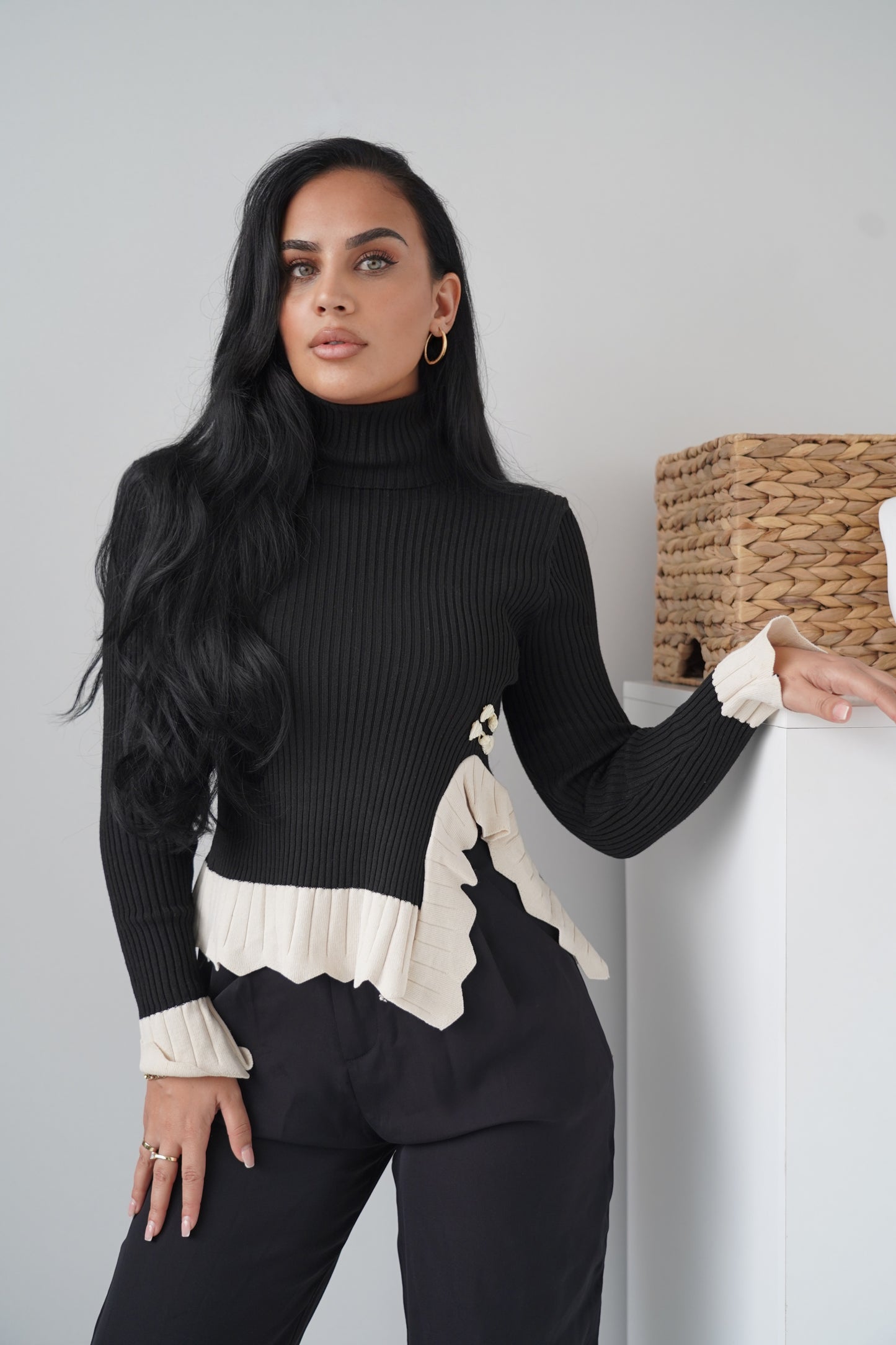 Chic black ribbed knit blouse with a high turtleneck