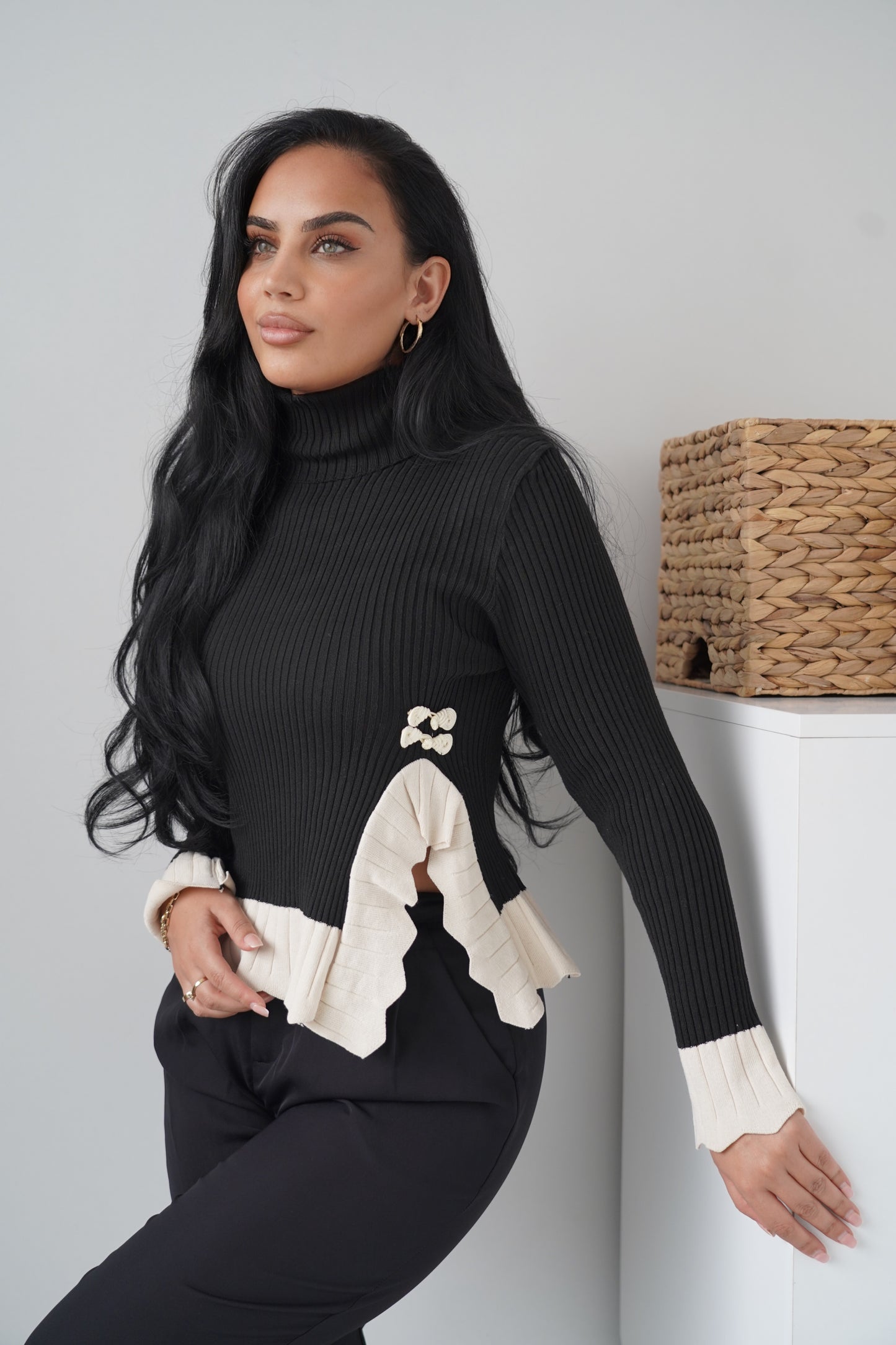 Chic black ribbed knit blouse with a high turtleneck