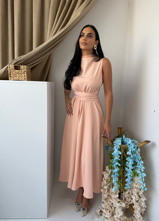Soft and elegant sleeveless midi dress in a delicate blush pink tone.