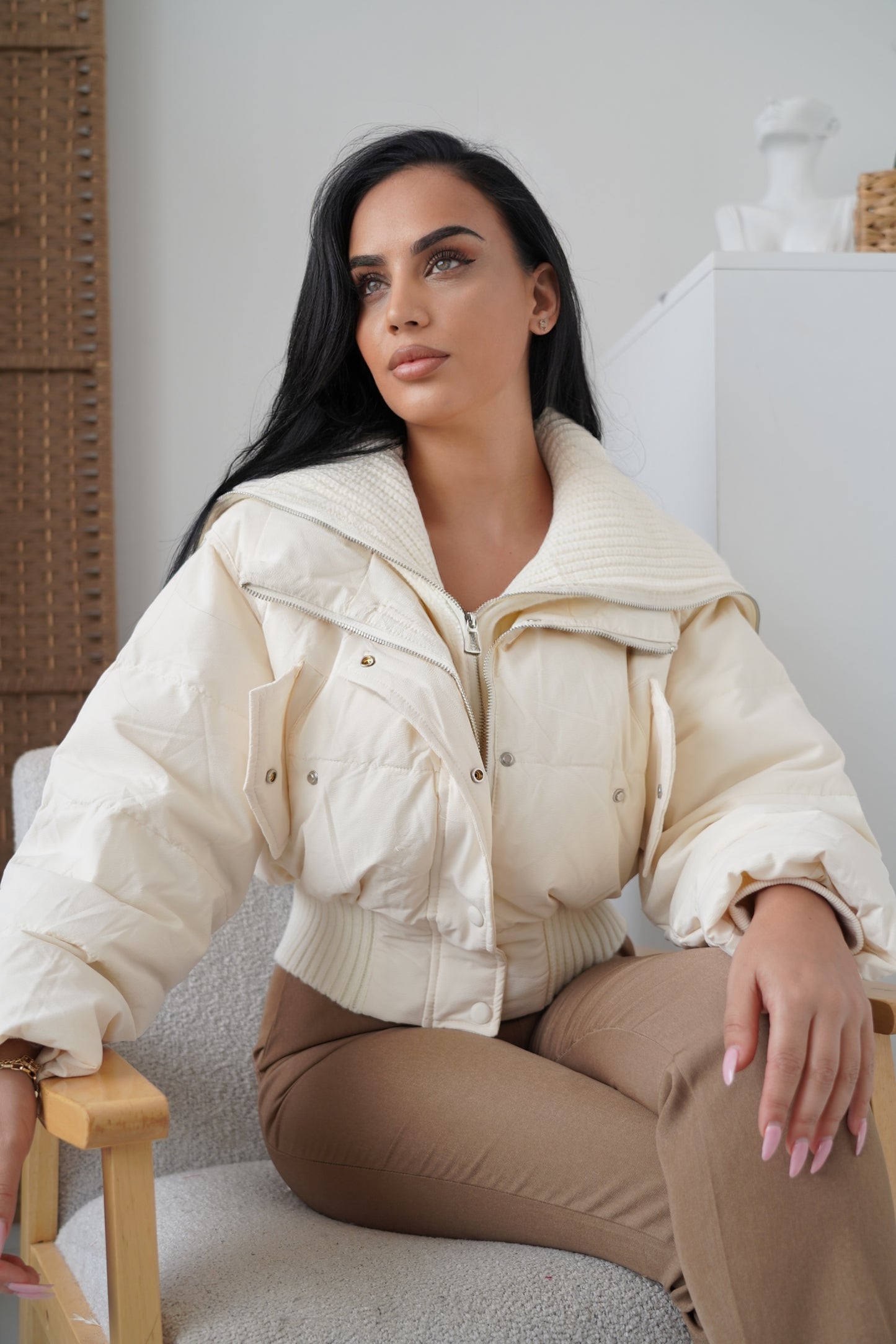 Trendy cream-colored puffer jacket crafted with warm fabric and a unique wide-collar design.