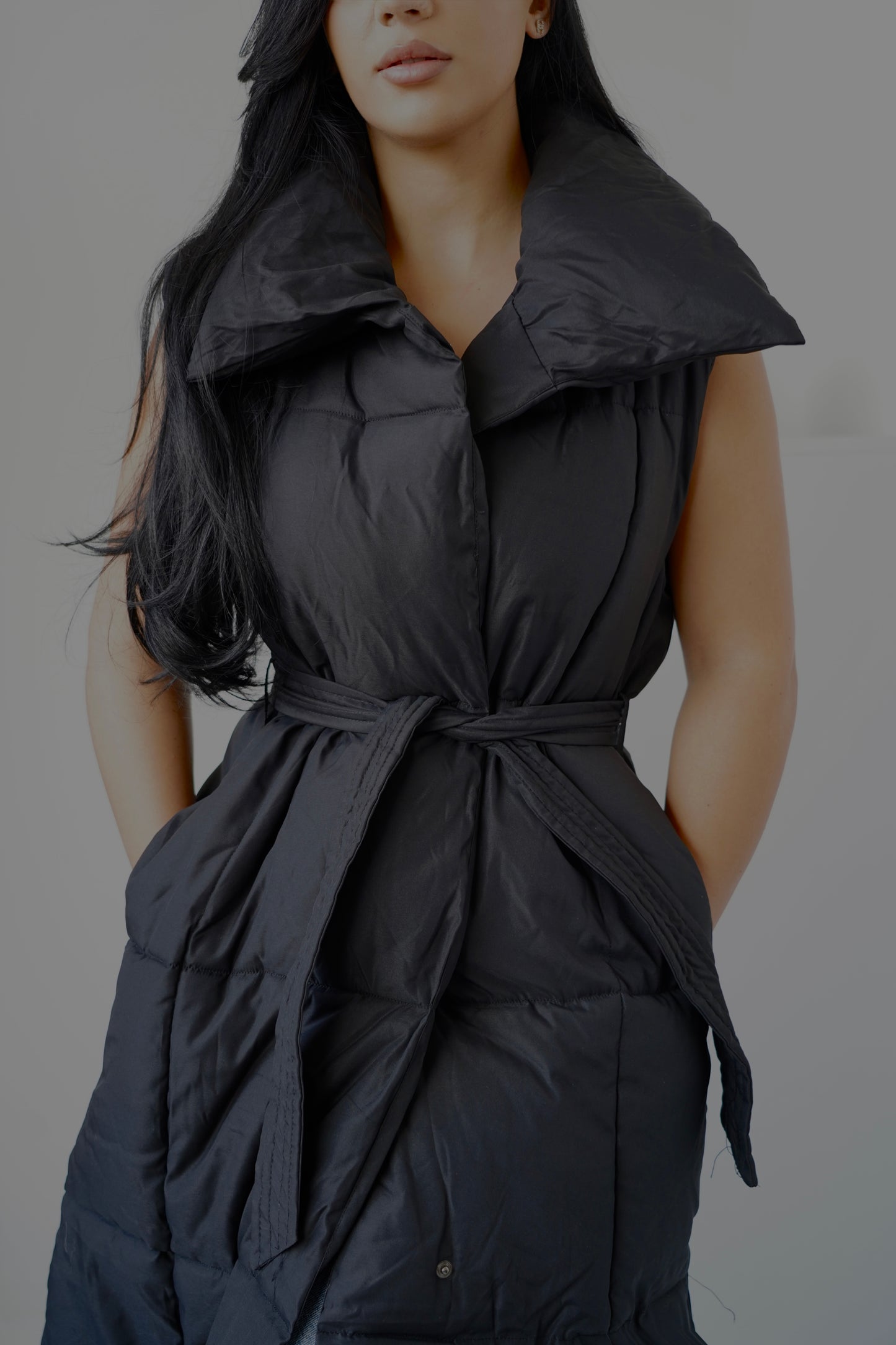 Long sleeveless padded vest designed for comfort and warmth.