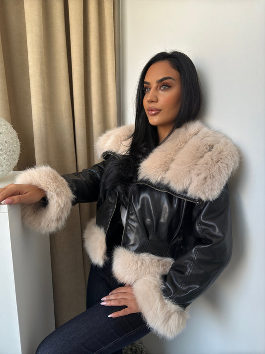 Black faux leather jacket finished with soft beige faux fur trim on the collar, sleeves, and hem.