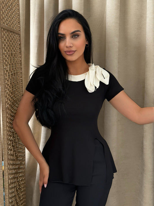 Elegant black blouse with a white collar and ribbon details perfect for formal and chic looks.