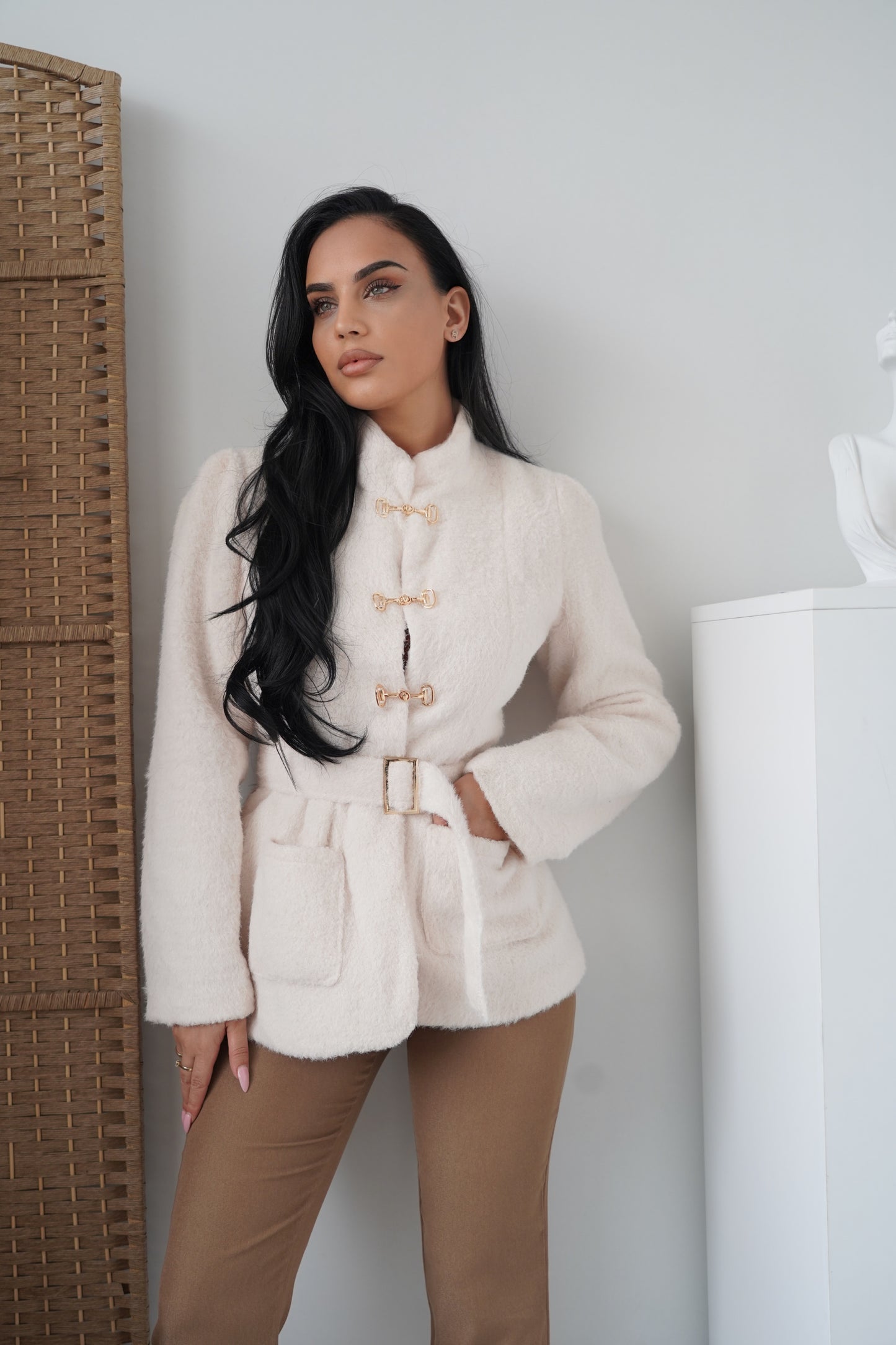 Elegant cream-colored jacket made from a soft, warm fabric, designed for a chic and sophisticated look.