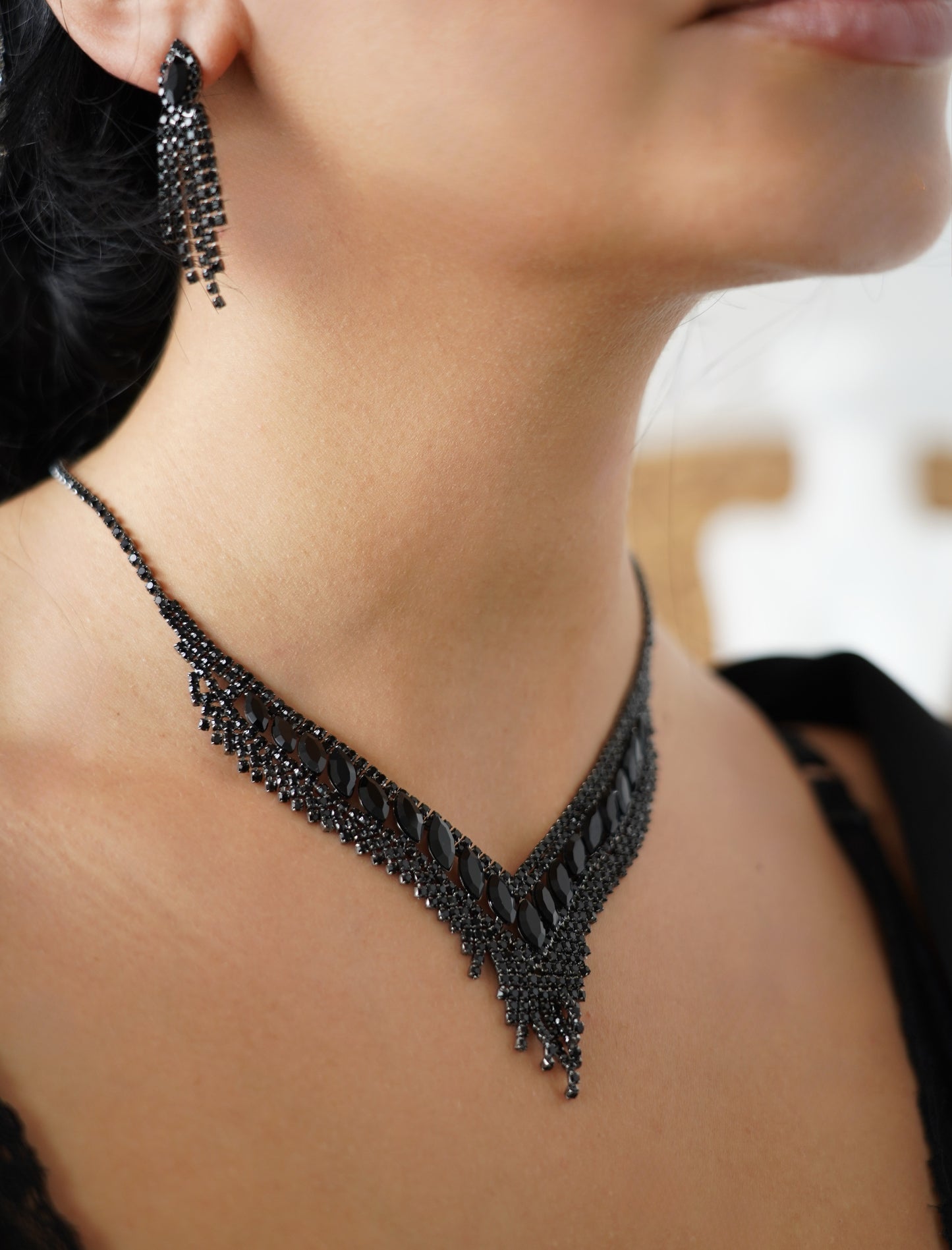 Stunning black jewelry set featuring a statement V-shaped necklace